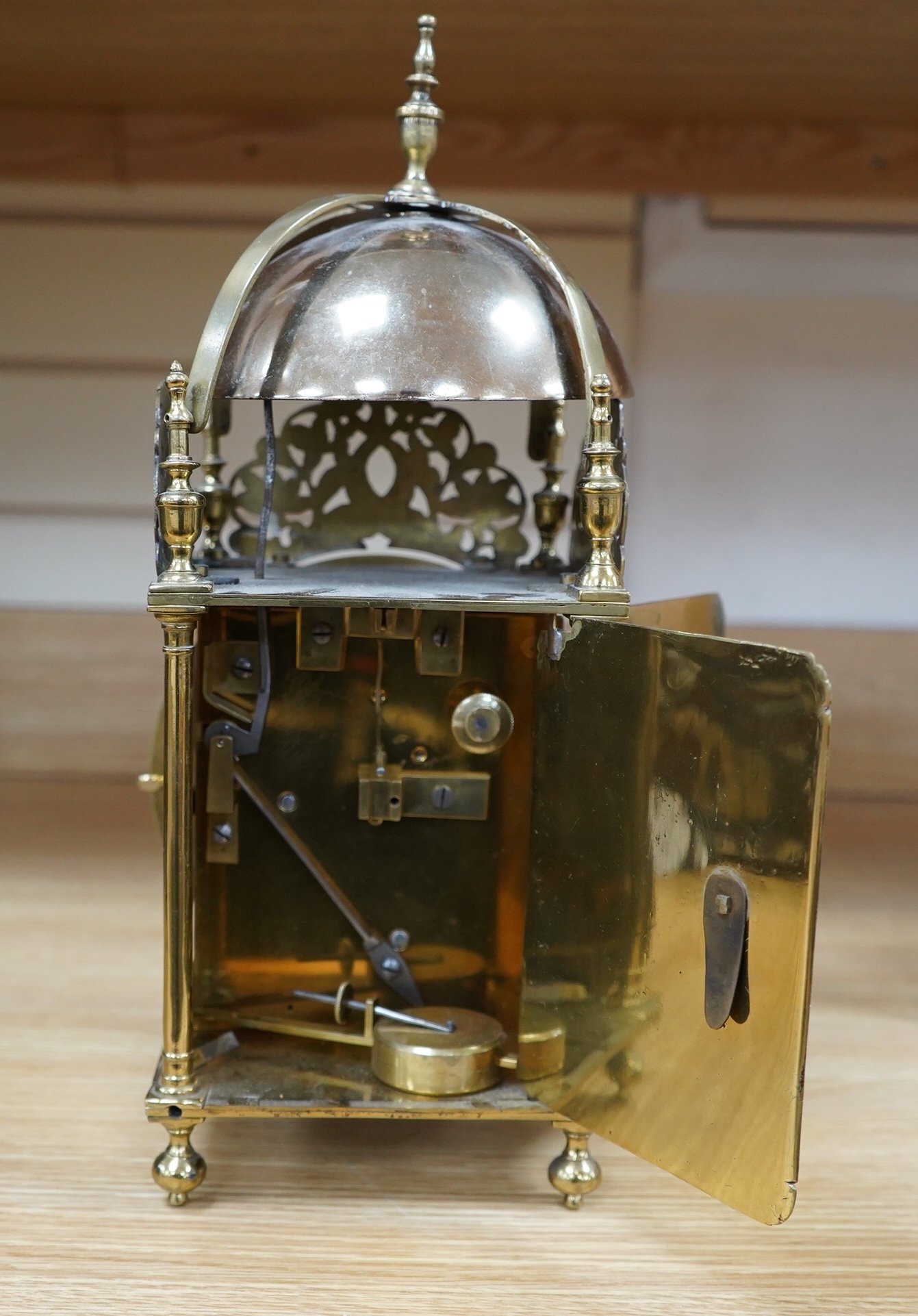 Manner of Richard Rayment of Bury. A Victorian 17th century style lantern clock, in traditional brass case with silvered Roman dial and eight day single fusee movement striking on a bell, 17cm wide, 14.5cm deep, 38cm hig